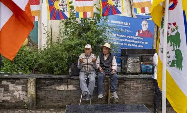 Two elderly exiled Tibetans wait to welcome their spiritual leader the Dalai Lama before he arrives in Dharamshala, India, Wednesday, Aug. 28, 2024. (AP Photo/Ashwini Bhatia)