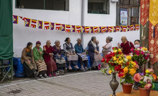 Exiled Tibetans wait to welcome their spiritual leader the Dalai Lama before he arrived in Dharamshala, India, Wednesday, Aug. 28, 2024. (AP Photo/Ashwini Bhatia)