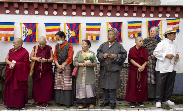 Exiled Tibetans wait to welcome their spiritual leader the Dalai Lama before he arrived in Dharamshala, India, Wednesday, Aug. 28, 2024. (AP Photo/Ashwini Bhatia)