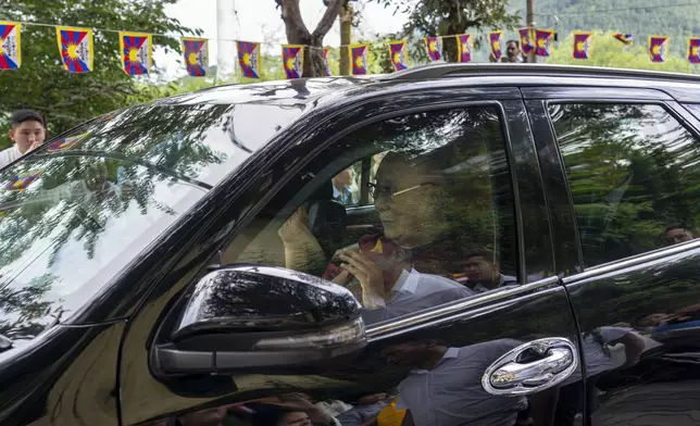 Tibetan spiritual leader the Dalai Lama greets a welcoming crowd from inside his car on his arrival in Dharamshala, India, Wednesday, Aug. 28, 2024. (AP Photo/Ashwini Bhatia)