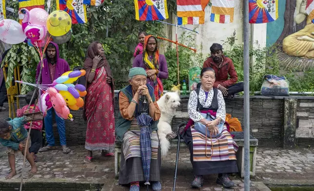 Exiled Tibetans wait to welcome their spiritual leader the Dalai Lama before he arrived in Dharamshala, India, Wednesday, Aug. 28, 2024. (AP Photo/Ashwini Bhatia)