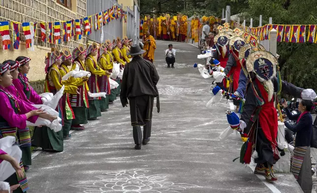 Exiled Tibetans in costumes practice a traditional dance to welcome their spiritual leader the Dalai Lama before he arrives in Dharamshala, India, Wednesday, Aug. 28, 2024. (AP Photo/Ashwini Bhatia)