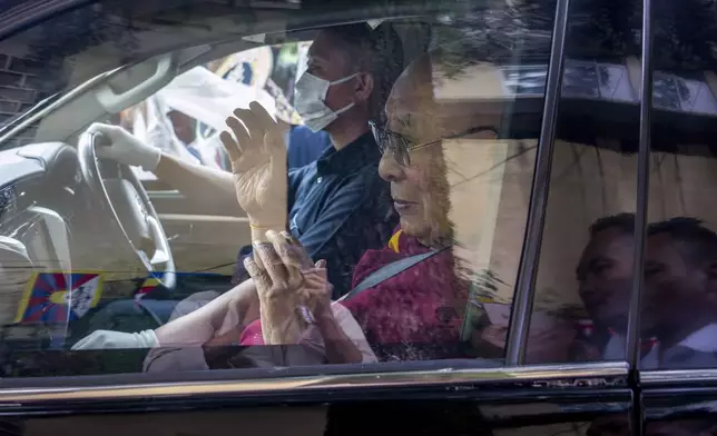 Tibetan spiritual leader the Dalai Lama greets a welcoming crowd from inside his car as he arrives in Dharamshala, India, Wednesday, Aug. 28, 2024. (AP Photo/Ashwini Bhatia)