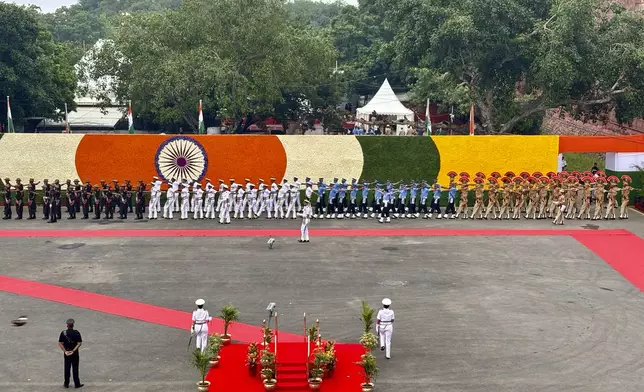 A joint contingent of Indian army, air force and navy march in to present guard of honor to Indian Prime Minister Narendra Modi before his arrival at the 17th century Mughal-era Red Fort monument for the country's Independence Day celebrations in New Delhi, India, Thursday, Aug. 15, 2024. (AP Photo/Manish Swarup)