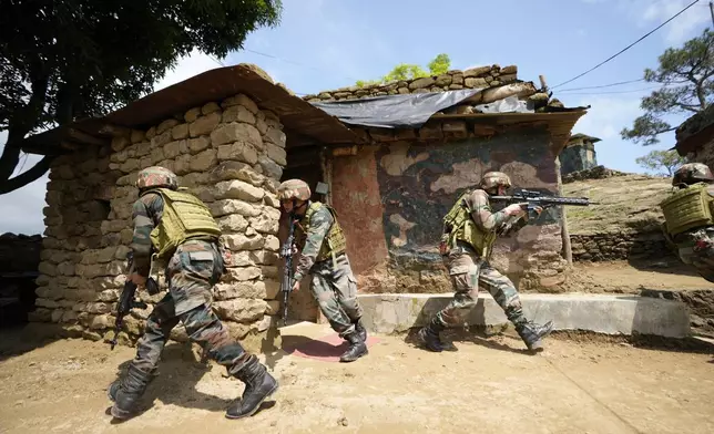 Indian army soldiers participate in a mock drill along the highly militarized Line of Control that divides Kashmir region between India and Pakistan, in Nowshera sector about 127 kilometers (79 miles) from Jammu, India, Monday, Aug.12, 2024. (AP Photo/Channi Anand)