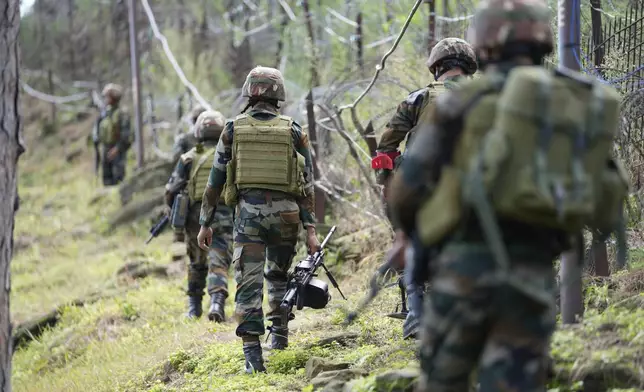 Indian army soldiers patrol along the highly militarized Line of Control that divides Kashmir region between India and Pakistan, in Nowshera sector about 127 kilometers (79 miles) from Jammu, India, Monday, Aug.12, 2024. (AP Photo/Channi Anand)