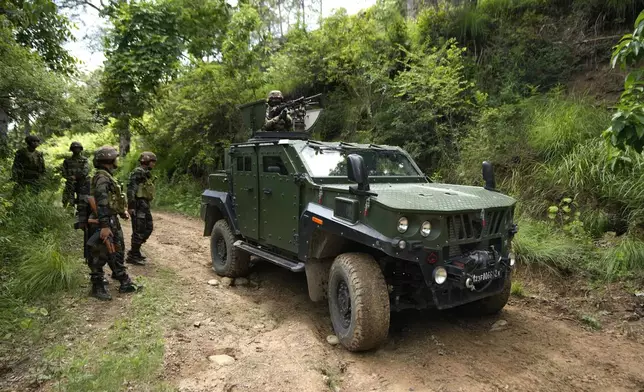 Indian army soldiers arrive for a mock drill in an armored vehicle at the highly militarized Line of Control that divides Kashmir region between India and Pakistan, in Nowshera sector about 127 kilometers (79 miles) from Jammu, India, Monday, Aug.12, 2024. (AP Photo/Channi Anand)