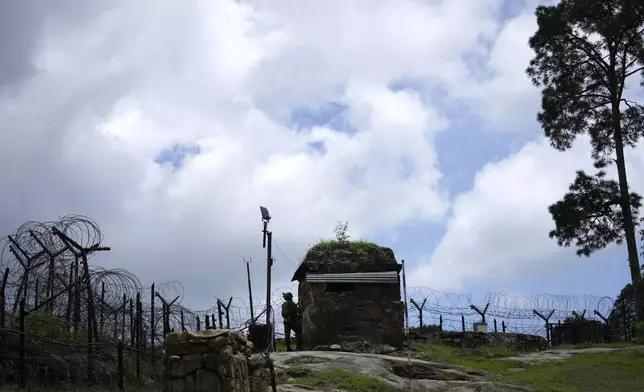 An Indian army soldier attends a mock drill along the highly militarized Line of Control that divides Kashmir region between India and Pakistan, in Nowshera sector about 127 kilometer (79 miles) from Jammu, India, Monday, Aug.12, 2024. (AP Photo/Channi Anand)