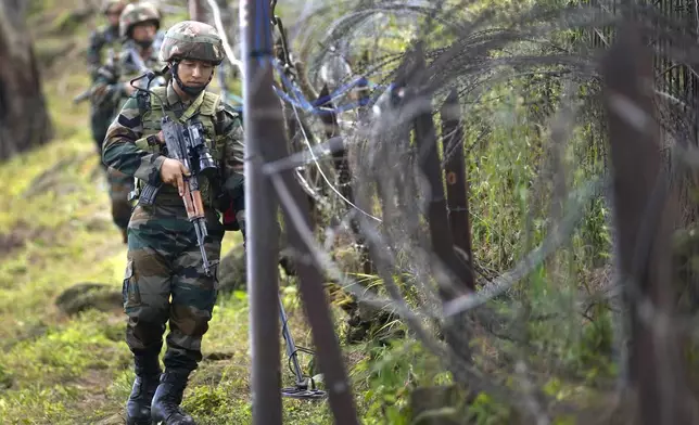 Indian army soldiers patrol along the highly militarized Line of Control that divides Kashmir region between India and Pakistan, in Nowshera sector about 127 kilometers (79 miles) from Jammu, India, Monday, Aug.12, 2024. (AP Photo/Channi Anand)