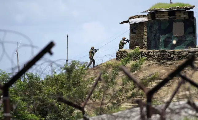 Indian army soldiers participate in a drill along the highly militarized Line of Control that divides Kashmir region between India and Pakistan, in Nowshera sector about 127 kilometers (79 miles) from Jammu, India, Monday, Aug.12, 2024. (AP Photo/Channi Anand)