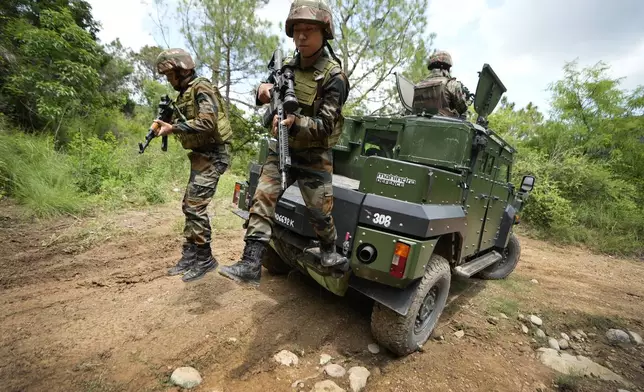 Indian army soldiers arrive for a mock drill in an armored vehicle along the highly militarized Line of Control that divides Kashmir region between India and Pakistan, in Nowshera sector about 127 kilometers (79 miles) from Jammu, India, Monday, Aug.12, 2024. (AP Photo/Channi Anand)