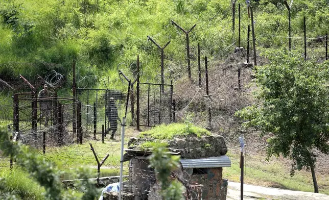 An Indian army soldier return after patrolling in no man's area along the highly militarized Line of Control that divides Kashmir region between India and Pakistan, in Nowshera sector about 127 kilometers (79 miles) from Jammu, India, Monday, Aug.12, 2024. (AP Photo/Channi Anand)