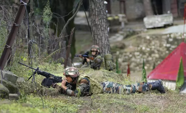 Indian army soldiers take position during a drill along the highly militarized Line of Control that divides Kashmir region between India and Pakistan, in Nowshera sector about 127 kilometers (79 miles) from Jammu, India, Monday, Aug.12, 2024. (AP Photo/Channi Anand)