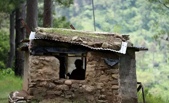 An Indian army soldier stands guard inside a bunker along the highly militarized Line of Control that divides Kashmir region between India and Pakistan, in Nowshera sector about 127 kilometers (79 miles) from Jammu, India, Monday, Aug.12, 2024. (AP Photo/Channi Anand)