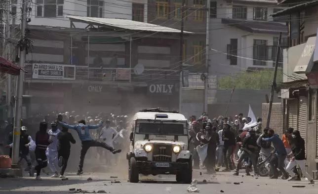 Kashmiri protesters throw bricks and rocks at an armored vehicle of Indian police during a protest in Srinagar, Indian controlled Kashmir, Friday, May 31, 2019. (AP Photo/Dar Yasin, File)