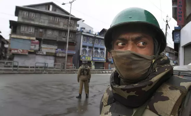 An Indian paramilitary soldier stands guard on a road during a curfew in Srinagar, India, Friday, Jan. 15, 2013. (AP Photo/ Mukhtar Khan,File)