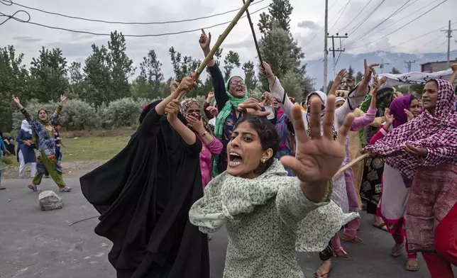 Women shout slogans as Indian policemen fire teargas and live ammunition in the air to stop a protest march in Srinagar, Indian controlled Kashmir, Aug. 9, 2019. (AP Photo/Dar Yasin, File)