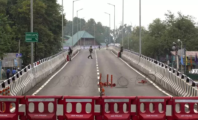 Indian paramilitary soldiers stand guard on a flyover during lockdown in Srinagar, Indian controlled Kashmir, Thursday, Aug. 15, 2019. (AP Photo/ Dar Yasin, File)