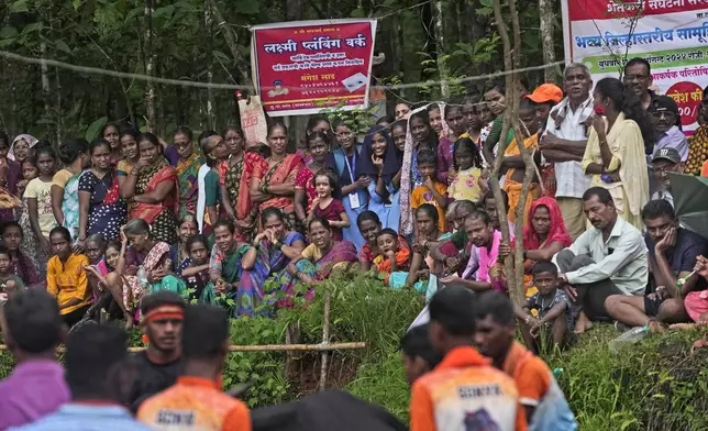 People watch a traditional oxen plow race known as Nangarni Spardha at Sarand village in Ratnagiri district, in the Indian state of Maharashtra, Thursday, Aug. 22, 2024. (AP Photo/Rajanish Kakade)