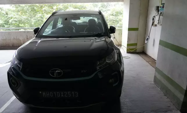 A car gets charged at an Electric Vehicle charging station at a residential building parking area in Mumbai, India, July 23, 2024. (AP Photo/Rajanish Kakade)