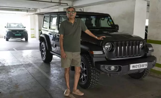 Hemant Suthar stands for a photograph beside his car in Mumbai, India, Friday, July 26, 2024. (AP Photo/Rajanish Kakade)