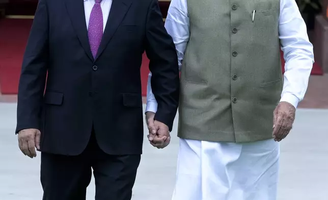 Indian Prime Minister Narendra Modi, right, and his Vietnamese counterpart Pham Minh Chinh walk together as the latter arrives for talks, in New Delhi, India, Thursday, Aug. 1, 2024. (AP Photo)