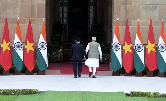 Indian Prime Minister Narendra Modi, right, and his Vietnamese counterpart Pham Minh Chinh walk together as the latter arrives for talks in New Delhi, India, Thursday, Aug. 1, 2024. (AP Photo)