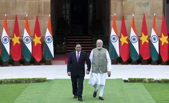 Indian Prime Minister Narendra Modi, right, and his Vietnamese counterpart Pham Minh Chinh walk together as the latter arrives for talks in New Delhi, India, Thursday, Aug. 1, 2024. (AP Photo)