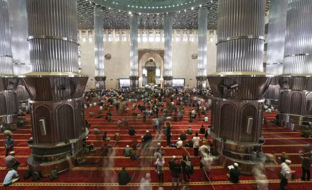 Muslim men leave after Friday prayers at Istiqlal Mosque in Jakarta, Indonesia, Friday, Aug. 9, 2024. (AP Photo/Tatan Syuflana)