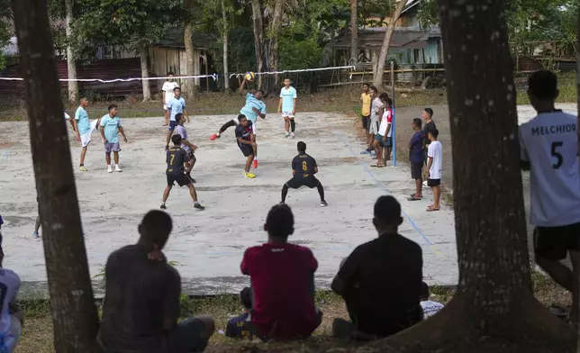 Seminarians play volleyball at Ritapiret Major Seminary in Maumere, East NusaTenggara province, Indonesia, Saturday, Saturday, Aug. 24, 2024. (AP Photo/Tatan Syuflana)