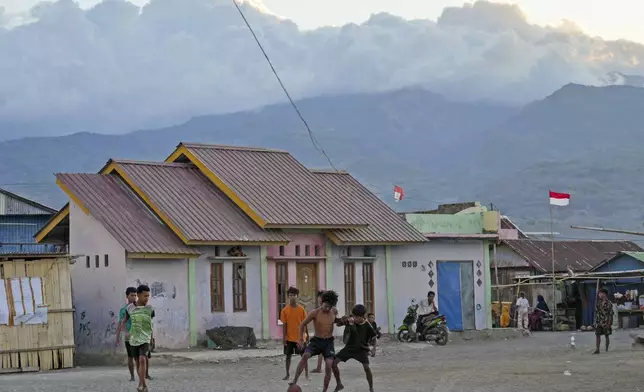 Boys play soccer in Maumere, East NusaTenggara province, Indonesia, Saturday, Saturday, Aug. 24, 2024. (AP Photo/Tatan Syuflana)