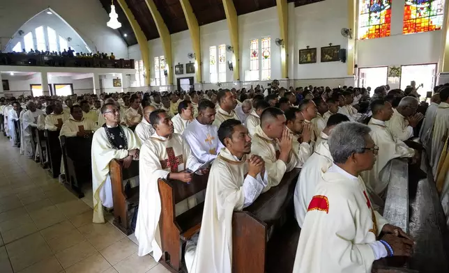 Catholic priests attend the ordination ceremony of Paulus Budi Kleden as the new bishop of Ende, at the Christ the King Cathedral church in Ende, East NusaTenggara province, Indonesia, Thursday, Aug. 22, 2024. (AP Photo/Tatan Syuflana)