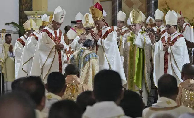 Bishops take part in the ordination ceremony of Paulus Budi Kleden as the new bishop of Ende, at the Christ the King Cathedral church in Ende, East NusaTenggara province, Indonesia, Thursday, Aug. 22, 2024. (AP Photo/Tatan Syuflana)