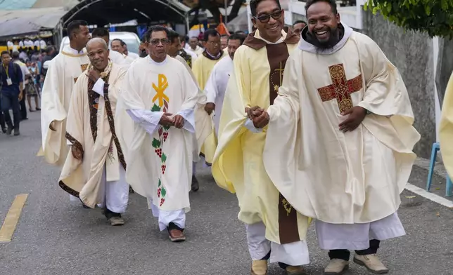 Catholic priests leave after the ordination ceremony of the Paulus Budi Kleden as the new bishop of Ende, at the Christ the King Cathedral church in Ende, East NusaTenggara province, Indonesia, Thursday, Aug. 22, 2024. (AP Photo/Tatan Syuflana)