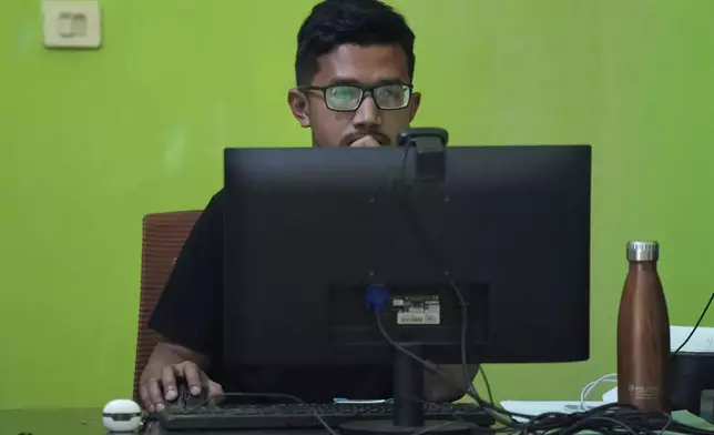 A former seminarian Arnoldus Yansen works on a computer at Ledalero Institute of Philosophy and Creative Technology in Maumere, East NusaTenggara province, Indonesia, Saturday, Aug. 24, 2024.(AP Photo/Tatan Syuflana)