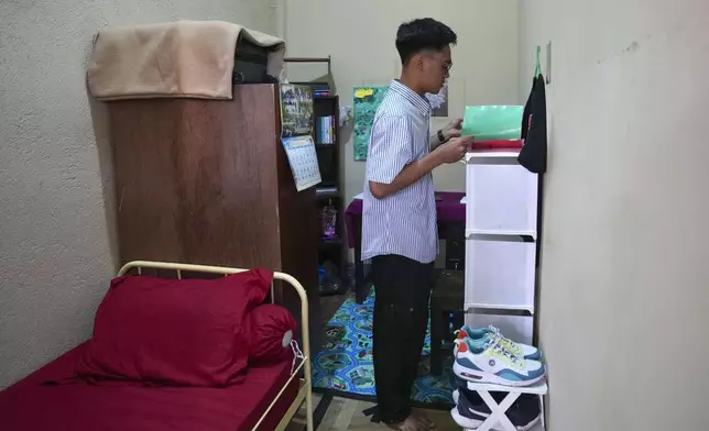 Seminarian Bernard Gredyo Sinagula prepares to start his day in his room at Ritapiret Major Seminary in Maumere, East NusaTenggara province, Indonesia, Friday, Aug. 23, 2024. (AP Photo/Tatan Syuflana)