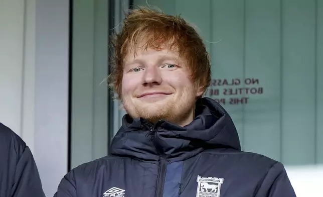 FILE - Ipswich Town fan Ed Sheeran in the stands before the Sky Bet Championship match at Portman Road, Ipswich, England, on Dec. 16, 2023. Sheeran has bought a small stake in the club ahead of its return to the Premier League. (Joe Giddens/PA via AP, File)