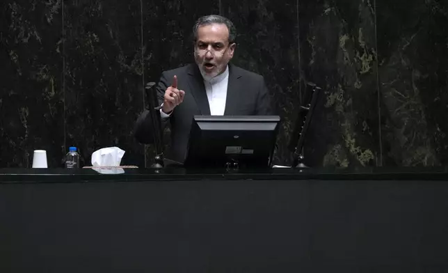 Nominee for foreign minister Abbas Araghchi speaks in an open session of parliament during the second day of debate on the 19 proposed ministers by Iranian President Masoud Pezeshkian in Tehran, Iran, Sunday, Aug. 18, 2024. Araghchi, 61, a career diplomat, was a member of the Iranian negotiating team that reached a nuclear deal with world powers in 2015 that capped Tehran's nuclear program in return for the lifting of sanctions. (AP Photo/Vahid Salemi)