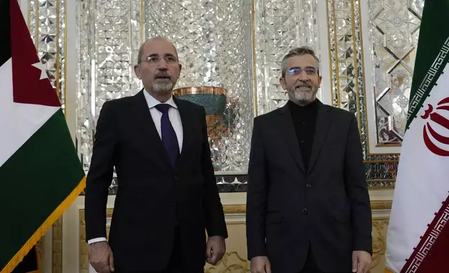 Iran's acting Foreign Minister Ali Bagheri Kani, right, welcomes Jordan's Foreign Minister Ayman Safadi for their meeting, in Tehran, Iran, Sunday, Aug. 4, 2024. (AP Photo/Vahid Salemi)