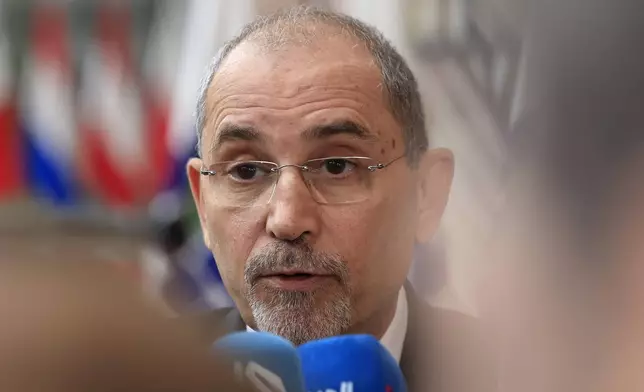 FILE - Jordan's Minister of Foreign Affairs Ayman Safadi speaks with the media as he arrives for a meeting at the European Council building in Brussels, Monday, May 27, 2024. Jordan's foreign minister is expected in Iran on Sunday, Aug. 4, 2025, according to Iranian media, as the United States and its Arab allies try to prevent a wider war after the back-to-back killings of top Iran-allied militants sparked vows of revenge against Israel. (AP Photo/Geert Vanden Wijngaert, file)