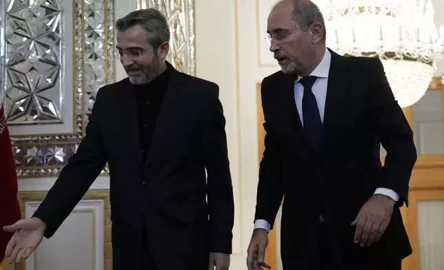 Jordan's Foreign Minister Ayman Safadi, right, is welcomed by Iran's acting Foreign Minister Ali Bagheri Kani, for their meeting in Tehran, Iran, Sunday, Aug. 4, 2024. (AP Photo/Vahid Salemi)