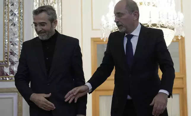 Jordan's Foreign Minister Ayman Safadi, right, is welcomed by Iran's acting Foreign Minister Ali Bagheri Kani, for their meeting in Tehran, Iran, Sunday, Aug. 4, 2024. (AP Photo/Vahid Salemi)