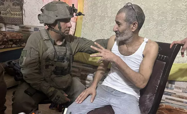 FILE - In this photo released by Israeli Defense Forces on Aug. 27, 2024, Qaid Farhan Alkadi, right, and the commanding officer of the 162nd Division, Brig. Gen. Itzik Cohen, talk after a rescue operation to free Alkadi. (Israeli Defense Forces via AP, File)