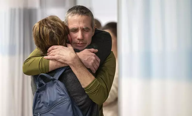 FILE - Freed hostage Fernando Simon Marman, right, hugs a relative after being rescued from captivity in the Gaza Strip, at the Sheba Medical Center in Ramat Gan, Israel, Feb. 12, 2024. (Israeli Army via AP, File)