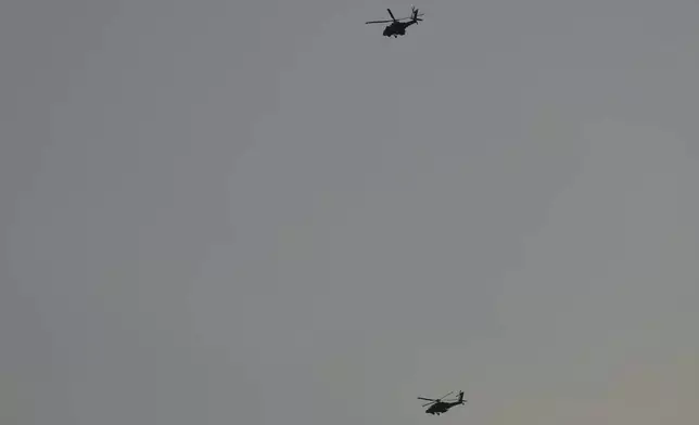 Israeli Apache helicopters fly toward northern Israel, Sunday, Aug. 25, 2024. (AP Photo/Ariel Schalit)