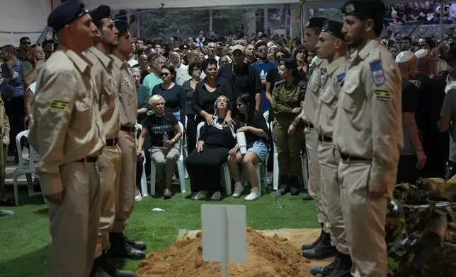 Relatives of Petty Officer 1st Class David Moshe Ben Shitrit, who was killed on a Hezbollah attack, mourn during his funeral at the Mount Herzl military cemetery in Jerusalem, Sunday, Aug. 25, 2024. (AP Photo/Ohad Zwigenberg)