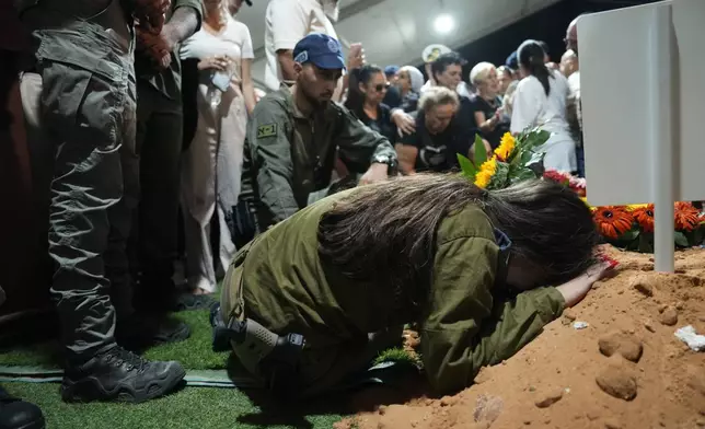 Hodaya, the sister of Petty Officer 1st Class David Moshe Ben Shitrit, who was killed on a Hezbollah attack, mourns during his funeral at the Mount Herzl military cemetery in Jerusalem, Sunday, Aug. 25, 2024. (AP Photo/Ohad Zwigenberg)