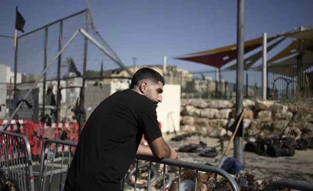 A man pauses at a makeshift memorial for 12 Druze children killed in a July rocket strike on a soccer field in Majdal Shams in the Israel-controlled Golan Heights, Sunday, Aug. 25, 2024, hours after Israel and Lebanon traded fire. (AP Photo/Maya Alleruzzo)