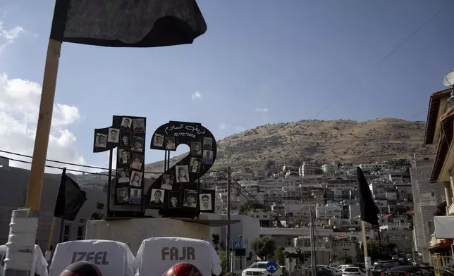 A makeshift memorial in a roundabout near where 12 Druze children were killed in a July rocket strike on a soccer pitch in Majdal Shams in the Israel-controlled Golan Heights, Sunday, Aug. 25, 2024, hours after Israel and Lebanon traded fire. (AP Photo/Maya Alleruzzo)