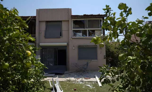 A damaged house is seen following an attack from Lebanon, in Acre, north Israel, Sunday, Aug. 25, 2024. (AP Photo/Ariel Schalit)